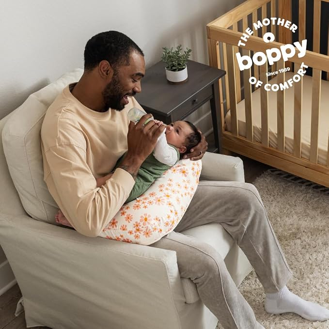 Boppy Nursing Pillow - Firm, Ergonomic U-Shaped Bottle and Breastfeeding Pillow with High Lift for Comfort and Support, Spacious Surface - Soft Pink Daisies