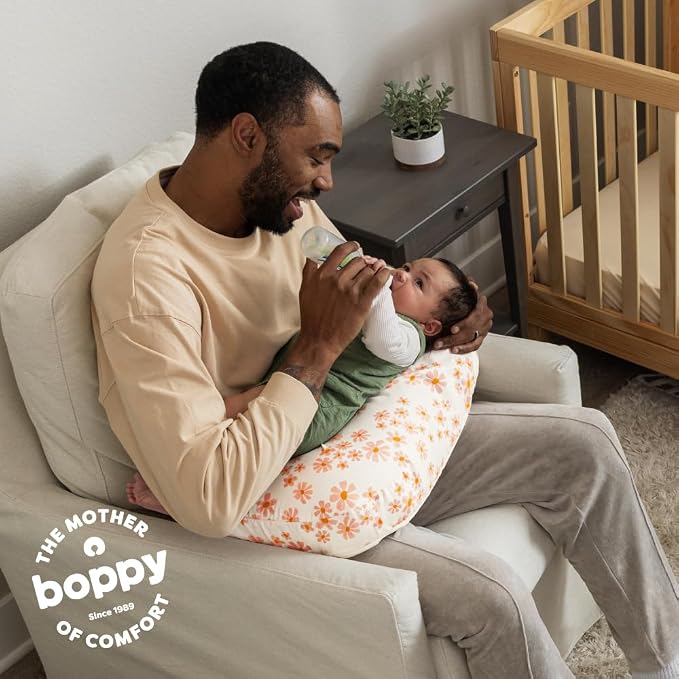 Boppy Nursing Pillow - Firm, Ergonomic U-Shaped Bottle and Breastfeeding Pillow with High Lift for Comfort and Support, Spacious Surface - Soft Pink Daisies