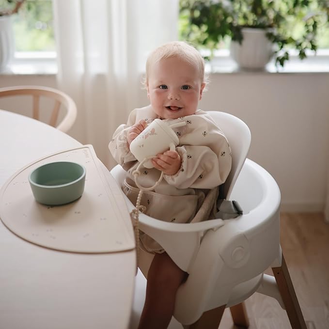 mushie Long Sleeve Baby Bib | Water Resistant Adjustable Fit for Ages 6-24 Months