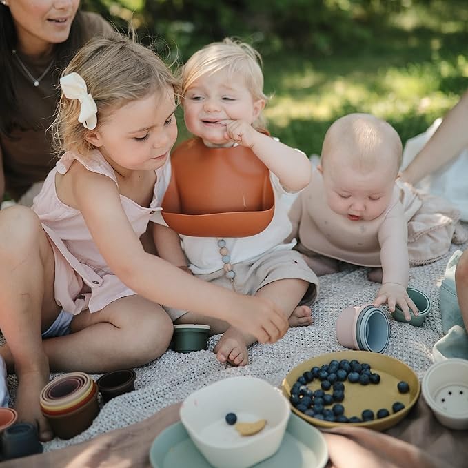 mushie Silicone Baby Bib | Adjustable Fit Waterproof Bibs (Cherries)
