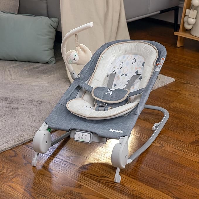 Ingenuity Gas Relief and Anti-Colic Baby Bouncer Seat and Rocker, Gentle Belly Massage to Relax and Soothe Bellies, Instant Tummy Soother, 20 Songs and Melodies – Parker